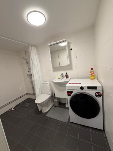 a small bathroom with a toilet and a microwave at Spacy flat with big garden in Södertälje
