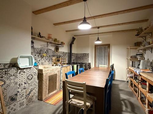 a kitchen with a long wooden table and chairs at B&B Scarpo & Supel in Nona
