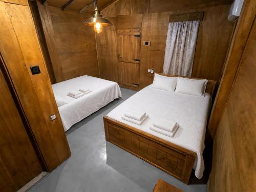 a small bedroom with two beds in a room at Vercour Tree House Cabana Sigiriya in Sigiriya