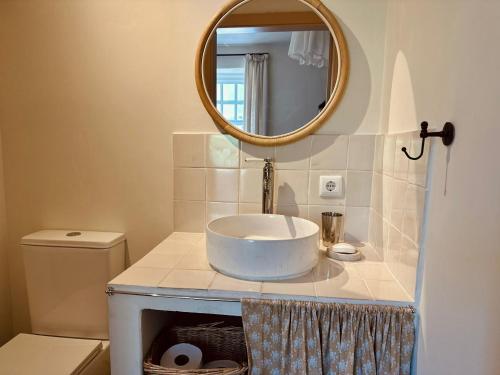 a bathroom with a sink and a mirror at Casa da Rigueira in Moreira do Lima