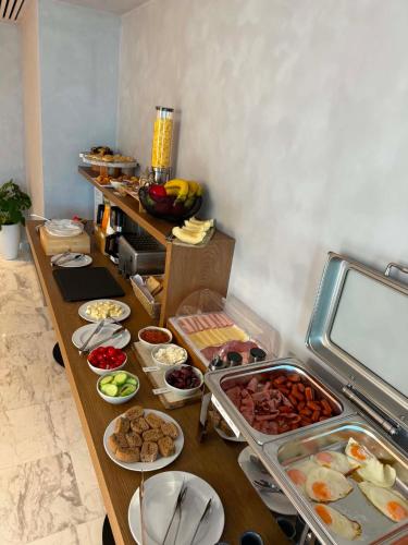 a buffet with many plates of food on a table at Theta Boutique Hotel in Chania