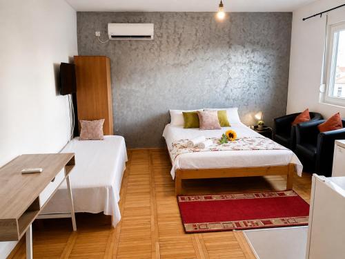 a small room with two beds and a table at Alice's Home in Surčin