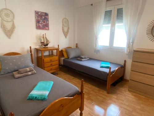 a living room with two beds and a couch at Vista al Mar in Piles