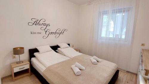 a bedroom with two beds with towels on them at Forest Apartman in Makó