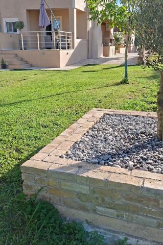 a rock garden in front of a house at Grand Skylight in Corfu