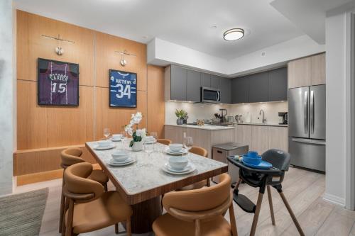 a kitchen and dining room with a table and chairs at Widmr Residences in Toronto