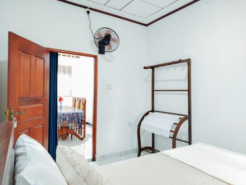 a bedroom with a bed and a chair and a mirror at Venuri Villa Midigama in Midigama East