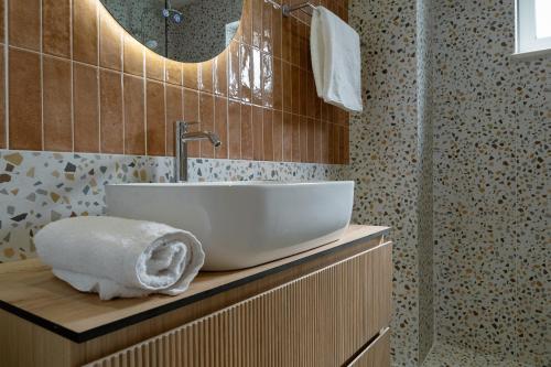 a bathroom with a white sink and a mirror at Marevia in Nopíyia