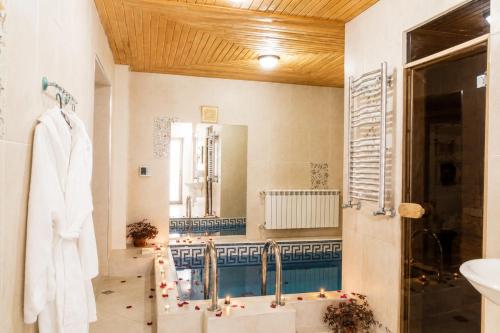 a bathroom with a tub and a sink and a mirror at White House SPA Hotel in Baku