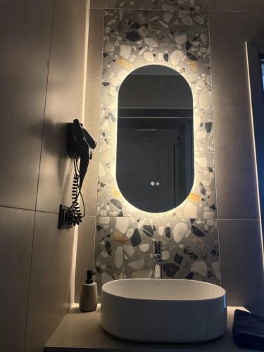 a bathroom with a sink and a mirror at Thess Living Suites in Thessaloniki
