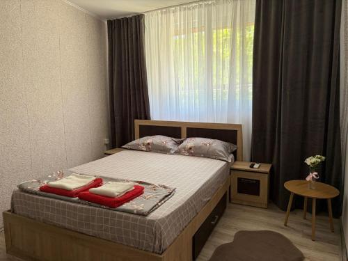 a bedroom with a bed with red towels on it at Casa Dorina 2 in Techirghiol