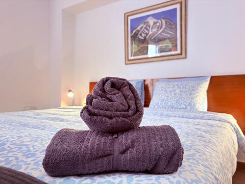 a pile of towels sitting on top of a bed at Casa Lana - Cozy Beachside Studio in Puertito de Güímar
