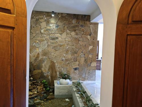 a stone wall in the hallway of a house at Moksha Villa-Hostel Kandy in Kandy