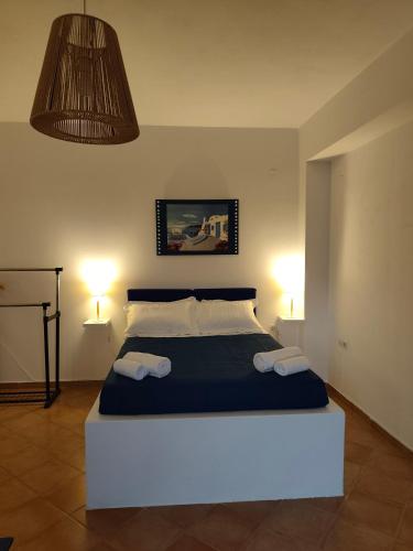 a bedroom with a large bed with two towels on it at ENDLESS BLUE Milos in Provatas
