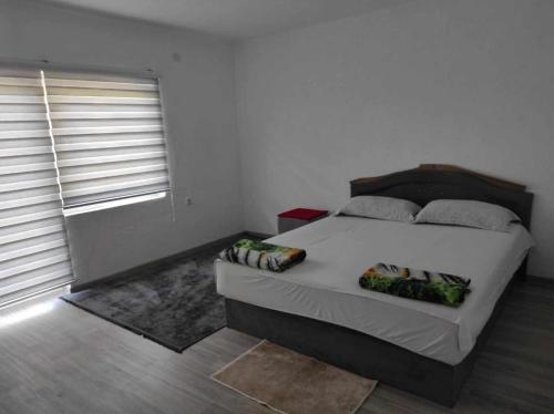 a bedroom with a large bed in a room at Apartman Dzans in Jajce
