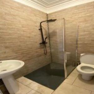 a bathroom with a shower and a toilet and a sink at Alexander's luxury rooms all en-suite, spa bath in Blackpool