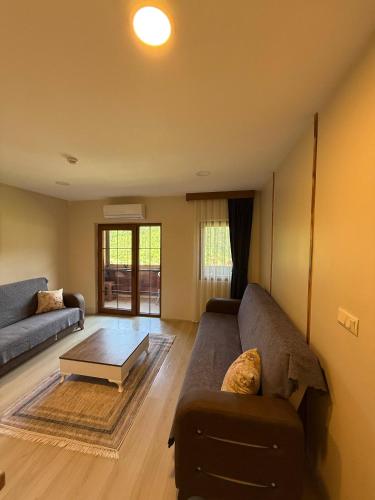 a living room with a couch and a coffee table at Erkonak Pansiyon in Uzungöl