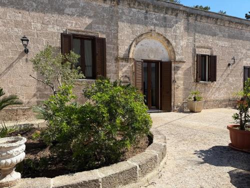 an entrance to a stone building with plants in front at CasaSignorina in Leuca