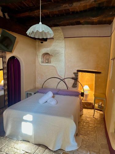 a bedroom with a bed with two towels on it at I tini in Cori