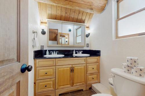a bathroom with two sinks and a mirror at Mogul Hill Cabin in Sandpoint