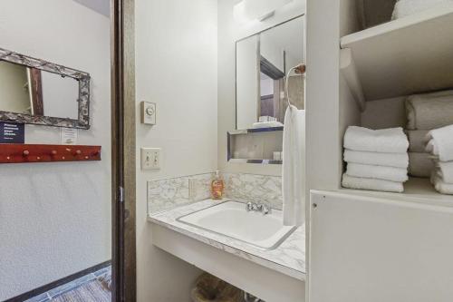 a bathroom with a sink and a mirror and towels at Red Cricket 22 in Sandpoint