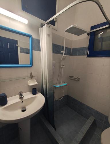 a bathroom with a sink and a shower at ENDLESS BLUE Milos in Provatas