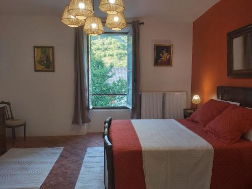 a bedroom with a bed and a large window at Chez jacky in Serres