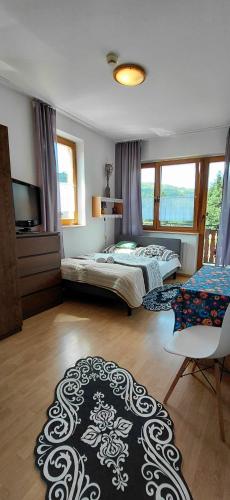 a bedroom with two beds and a large rug at Nova Szymusiowa in Szczyrk