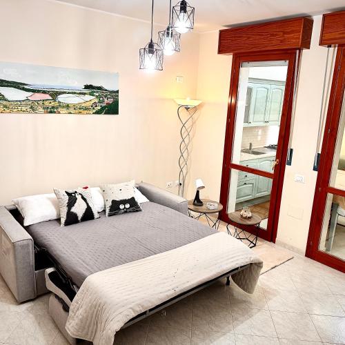 a bedroom with a bed and a large window at White House Quartu in Quartu SantʼElena