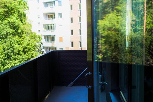 a balcony with a view of a building at Green Balcony Studio near Metro in Norsborg