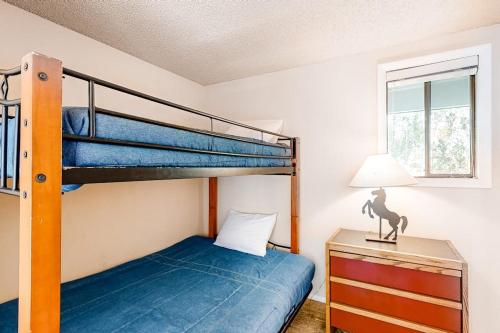 a bedroom with a bunk bed and a desk with a lamp at Western Dreams in Sun Valley