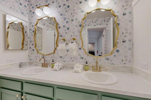 a bathroom with two sinks and two mirrors at Modern Alpine Getaway in Sun Valley