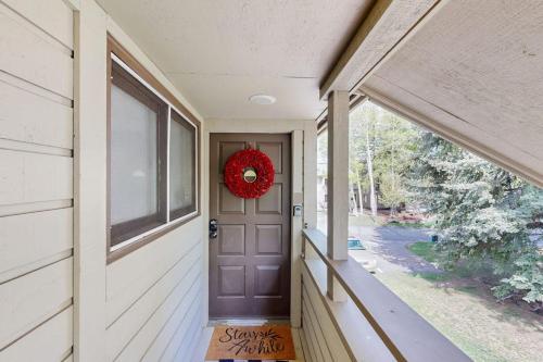 a christmas wreath on the door of a house at Modern Alpine Getaway in Sun Valley