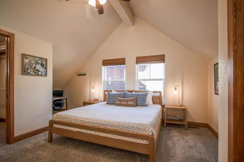 a bedroom with a bed with blue pillows and a window at Dover Bay Way in Dover