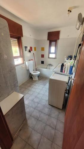 a bathroom with a tub and a toilet and a sink at Shaked בית שקד in Moshav Ramot