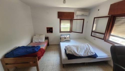 a room with two beds in a room at Shaked בית שקד in Moshav Ramot
