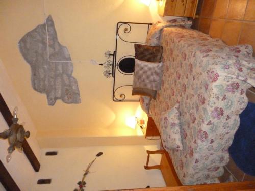 a bedroom with a bed with a cross on the wall at Casa El Cantón in La Cuba