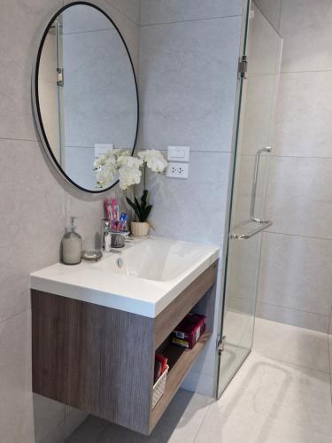 a bathroom with a sink and a mirror at Serenity Naiyang Най Янг D02 in Nai Yang Beach