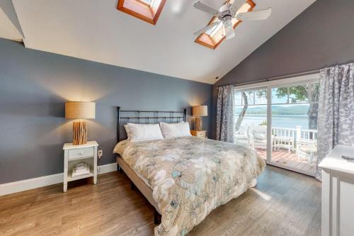 a bedroom with a bed and a large window at 4 Bed 2 Bath Vacation home in Ossipee in Ossipee