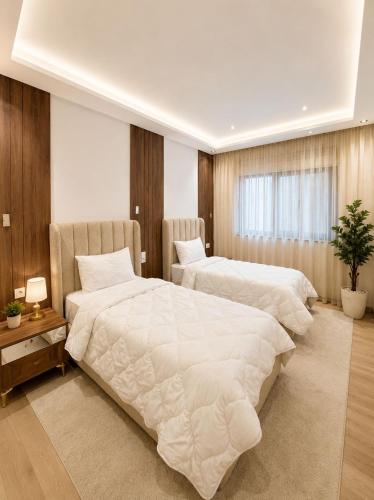 a bedroom with two beds and a window at Residence vigier in Tangier