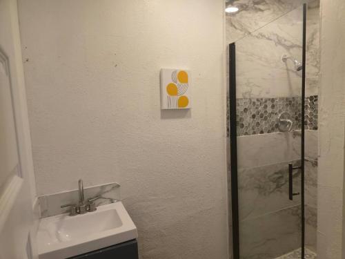 a bathroom with a toilet and a sink and a shower at Lakefront withTreehouse & Pool, Hottub, Gameroom in Azle