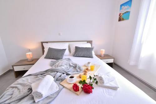 a bedroom with a bed with towels and flowers on it at Villa Natali in Pridraga