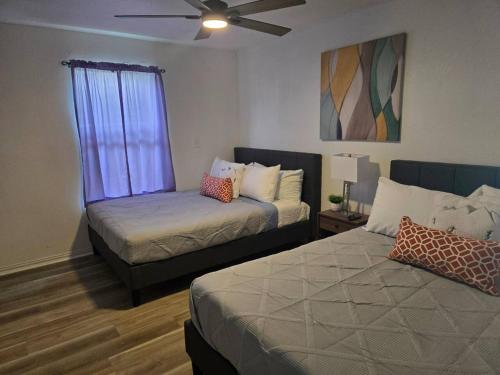 a bedroom with two beds and a window at Lakefront withTreehouse & Pool, Hottub, Gameroom in Azle