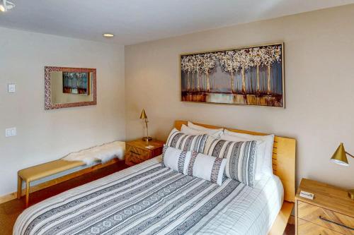 a bedroom with a bed and a table and a mirror at Sanctuary on Snow Creek in Sun Valley
