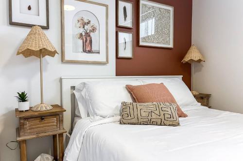 a bedroom with a white bed with a pillow on it at Chic Hideaway - King Bed - Fireplace - Garage - AC - DT and WEM in Edmonton
