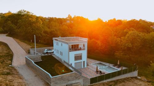 an aerial view of a house in the middle of a forest at Villa Dubrava in Matuzići