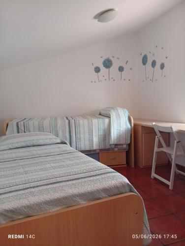 a bedroom with two beds and a desk with a chair at Can Mari in Ayna