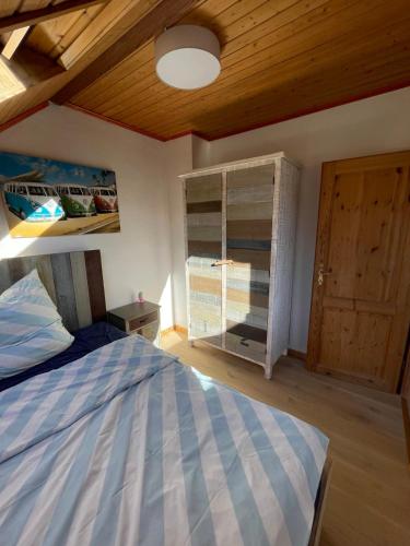 a bedroom with a bed and a wooden ceiling at Gasthaus Liam 4 in Bendorf