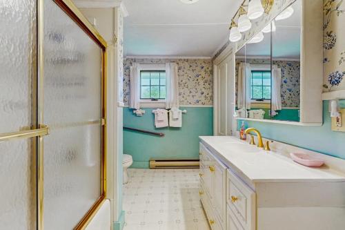 a bathroom with a shower and a sink and a toilet at Andrews Point Ocean Home in Rockport