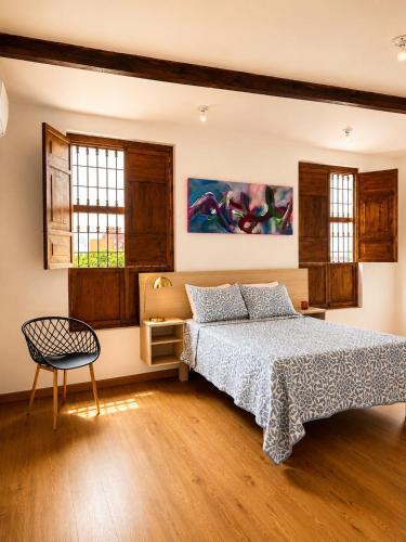 a bedroom with a bed and a chair in it at Tángara Home in Cali